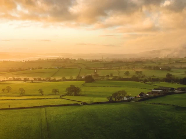 Image of sun shining over British countryside